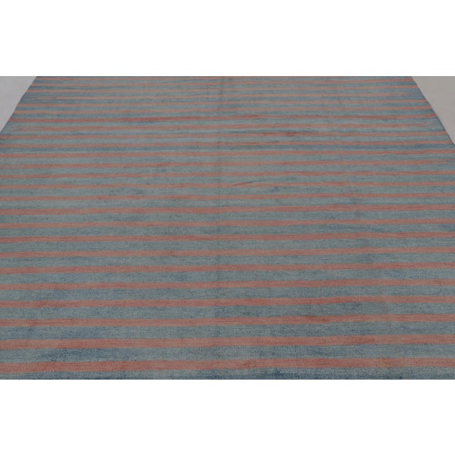 This 8x9 vintage rug is from a new collection of Dhurrie flat weaves in rare sizes and exceptional craftsmanship—an...