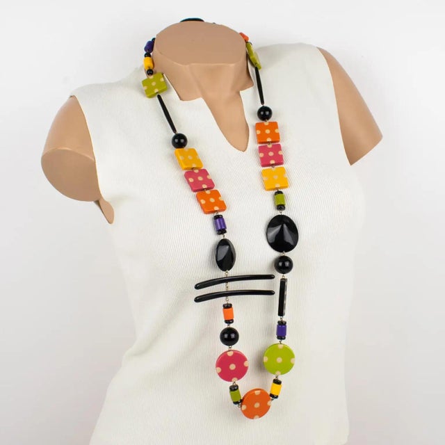 This gorgeous Angela Caputi, made-in-Italy, resin and Lucite extra-long necklace, has a playful design. The piece boasts...