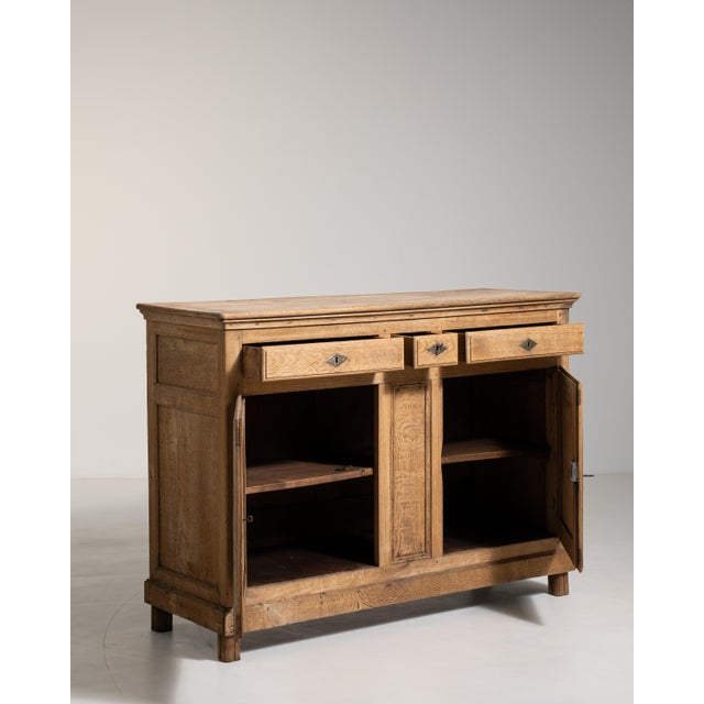 Hailing from the sun-drenched south of France, this magnificent 19th-century Provençal oak buffet exemplifies the robust...