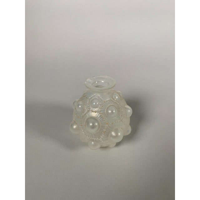 Vase signed René Lalique (1860-1945), "Sunflower" model, 1927. "Sunflower" model vase in slightly opalescent white pressed...