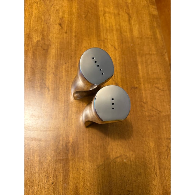 Bring an iconic piece of award-winning Postmodern design to your tabletop with this vintage "Kissing" salt and pepper...