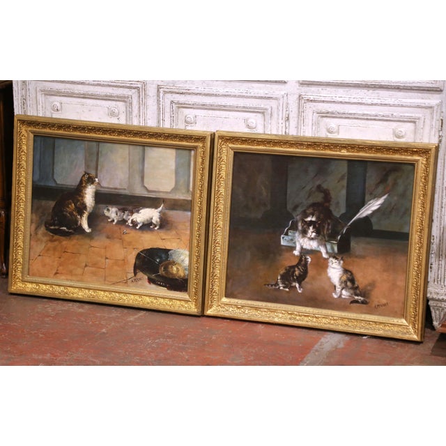 This charming pair of antique French paintings, executed circa 1860, depicts intimate interior scenes of cats and kittens...