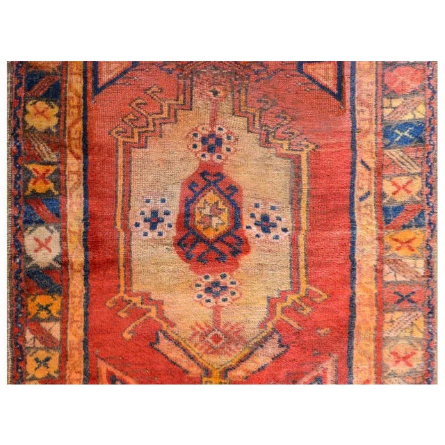 A wonderful early 20th century Turkish Anatolian rug with a large central medallion woven in indigo, cream, orange, and...