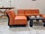 Five "amanta" modular armchairs by mario bellini for b&b italia in cognac-colored vegan leather with a black plastic base....
