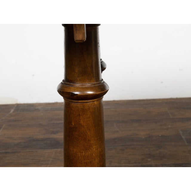 An Italian walnut trestle table from the 19th century, with column shaped legs. Created in Italy during the 19th century,...