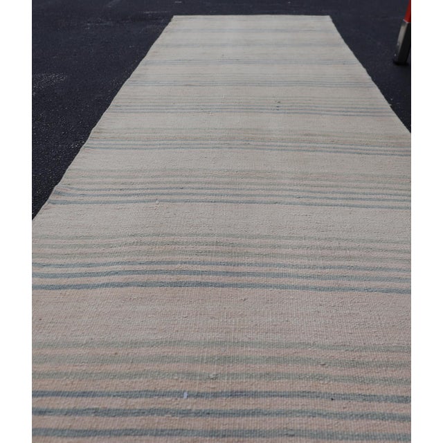 Measures: 2'7" x 11'1" Stripe Design Turkish Vintage Kilim Runner in Shades of Ivory and Light Blue. Keivan Woven Arts /...
