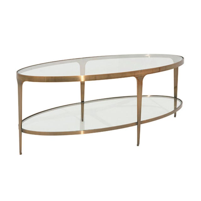 Simple in appearance yet substantial in style, the oval Brando ABR coffee table showcases two glass shelves framed in warm...