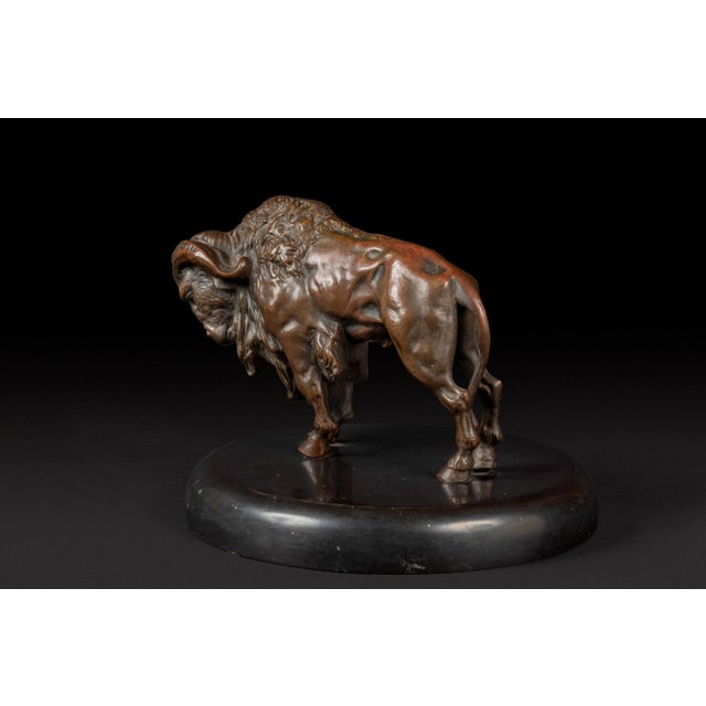 The bronze bison This bronze animal sculpture represents a bison in a walking position, giving off an impression of power...
