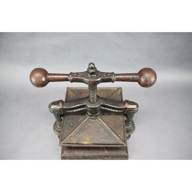 Exceptional antique cast iron bookbinding press dating from around 1900, featuring a highly decorative cast-iron frame,...
