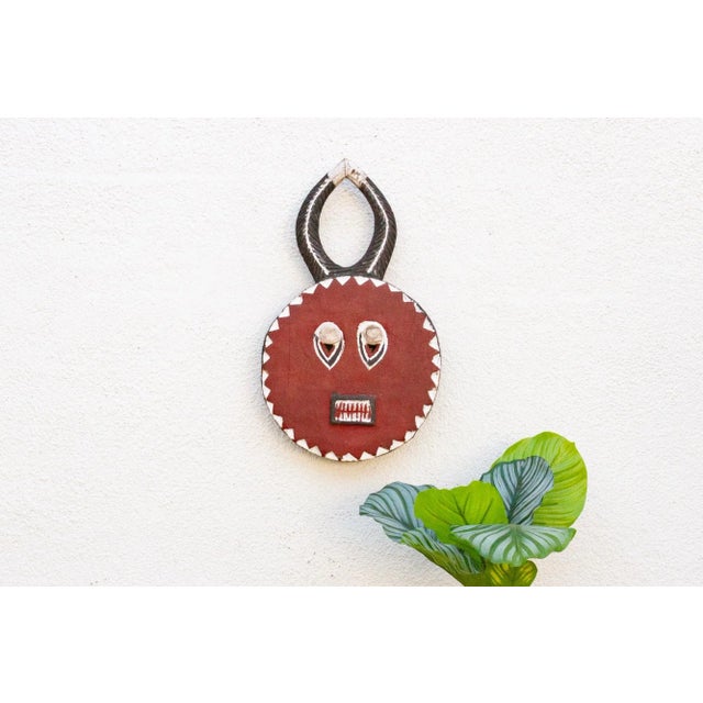 A charming African art piece, this Kple Kple mask belongs to the Goli mask group and is a symbol of fertility in...