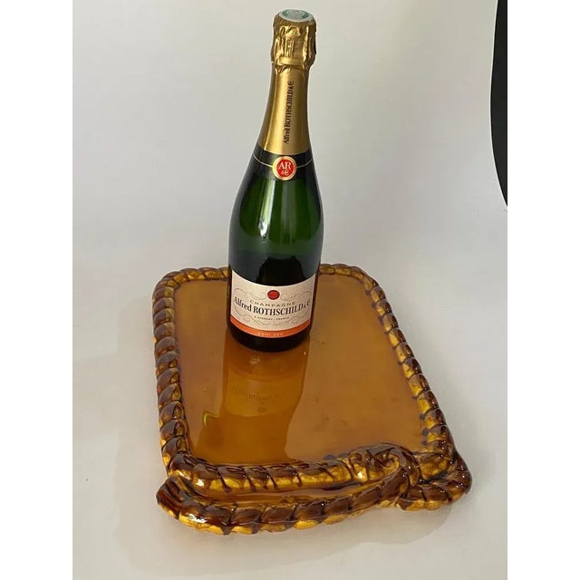 Ceramic dish in brown, yellow and orange color. This is a dish that was made in the 1960s, in Vallauris, France. It's...