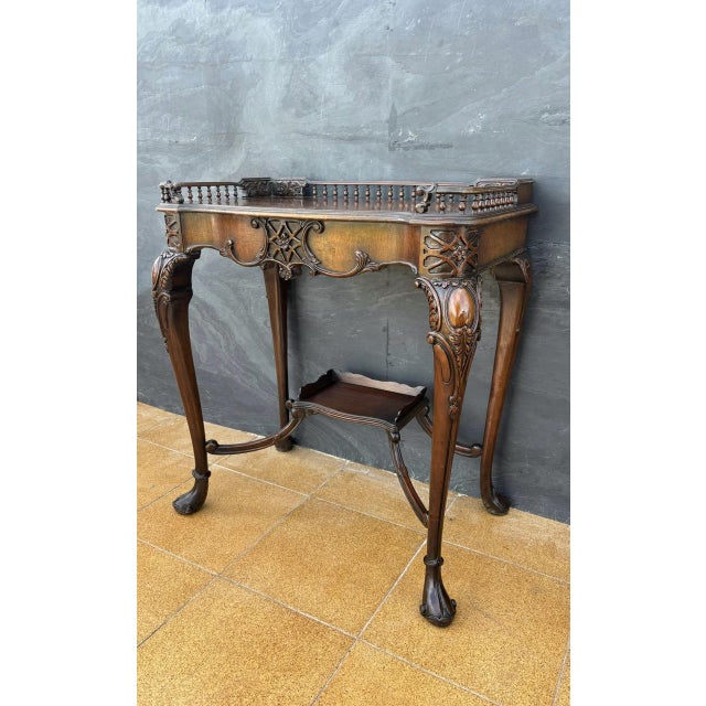 Elegant Louis XV style carved wood side table featuring a refined gallery top and gracefully curved cabriole legs. Richly...