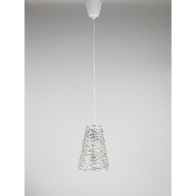 A delicate, petite mid-century modern pendant lamp from the 1950s, produced by j.t. Kalmar vienna in austria. The fixture...