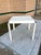 A square game table from the 1980s, wrapped in textured linen and finished in an ivory lacquer. Rounded waterfall edges...