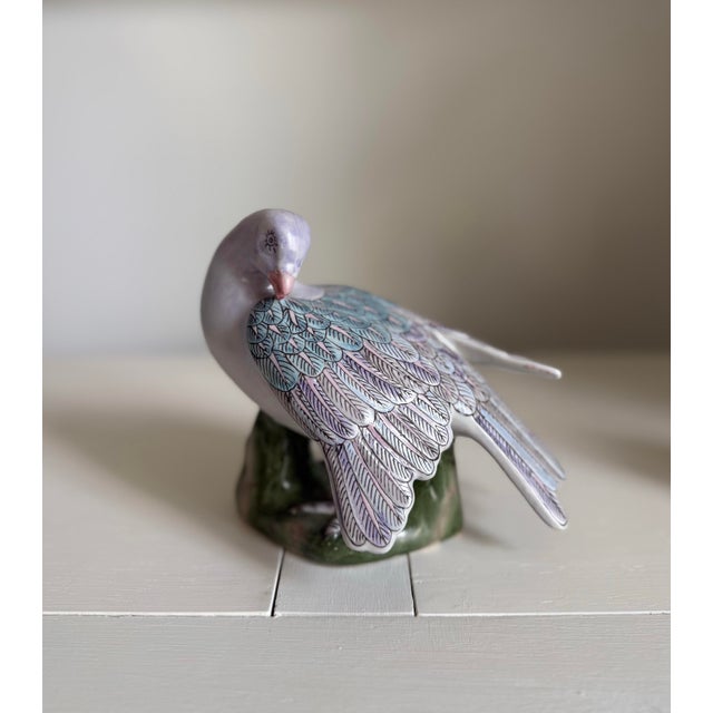 Lovely pair of bird figurines in shades of lavender. Perfect for mantle , bookcase or broken up on tabletops.