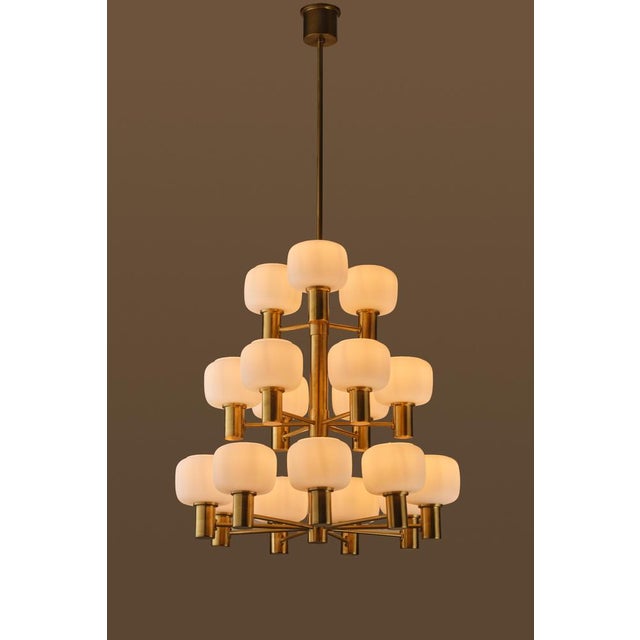 Excellent condition. Produced by Fagerhults Elektriska, Sweden, 1960s. Brass and opaline glass. Measures: Diameter 60 cm...