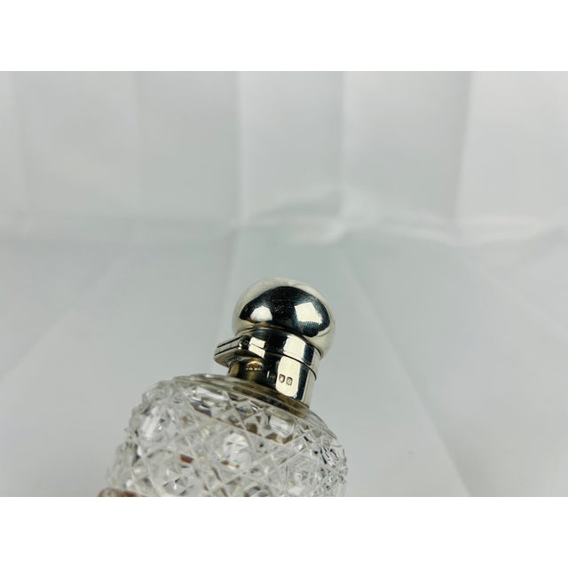 This exceptional Sterling Silver & Cut Glass Locking Hip Flask, crafted by the renowned London silversmiths Charles &...