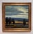 Shadows Across the Land captures a serene landscape where dark silhouettes of trees stand against a dramatic sky. The...