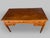 This Louis XVI-style desk is made of walnut with geometric maple and ebony inlays. The piece features five drawers on the...