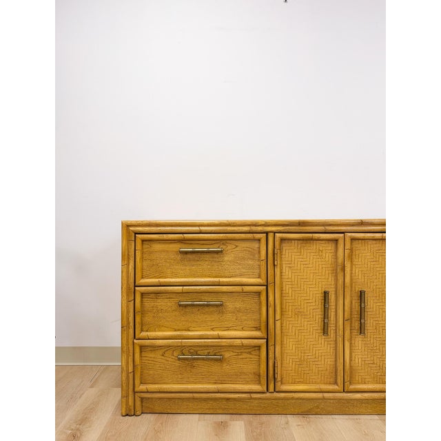 This gorgeous vintage Lea faux bamboo 9-drawer dresser is a warm and beautifully detailed coastal and Hollywood Regency...