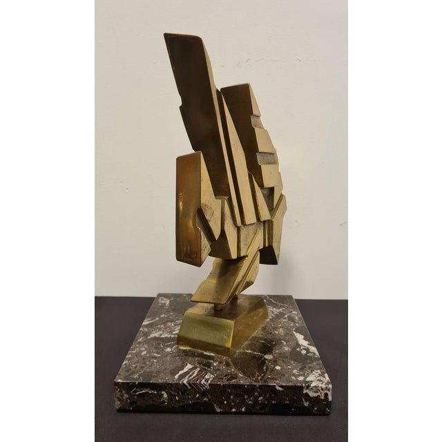 Sculpture made of brass and signed G. Banfi 88. Abstract work with a marble base made from a cast brass body that was then...