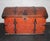 A Swedish 19th Century Orange Painted Chest with Wonderful Ironwork. This painted chest from Sweden is made from Wood and...