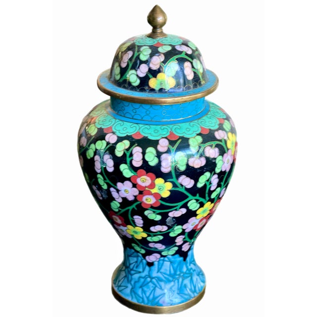 Colorful floral cloisonné ginger jar with lid with brass finial. Circa mid 20th century.