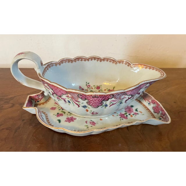 Antique 18th century Chinese famille rose porcelain sauce boat and tobacco leaf under plate. Decorated with peonies on a...