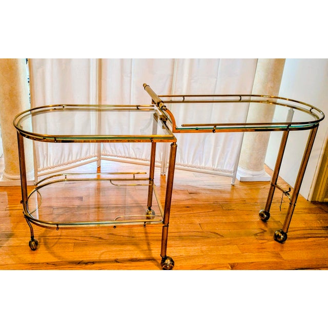 This Hollywood Regency swivel bar cart exudes glamor and classic design. It features three glass tops and a roll out...