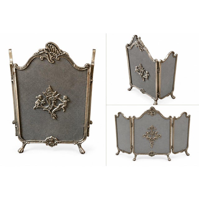 Elegant vintage three-panel folding fireplace screen French Neoclassicism metalwork, fine mesh panels, and richly detailed...