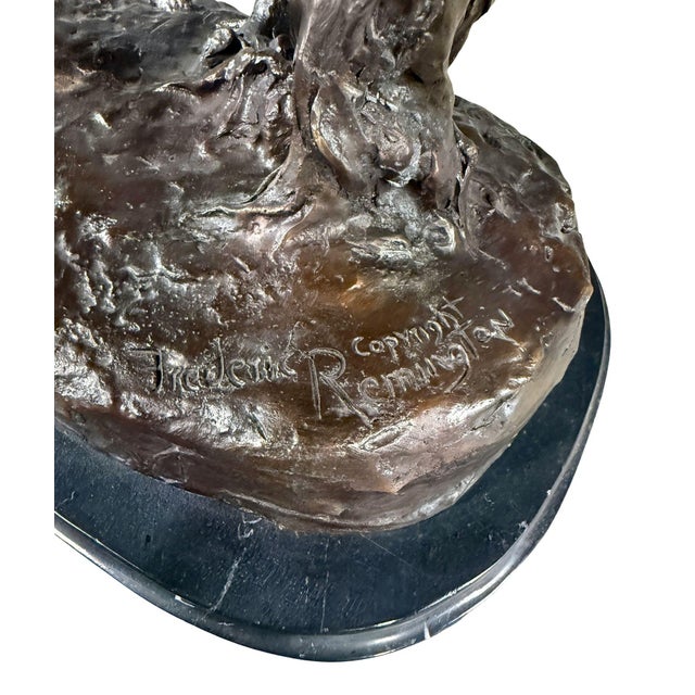 Large and dramatic bronze sculpture after Frederic Remington’s iconic Western composition The Rattlesnake, depicting a...