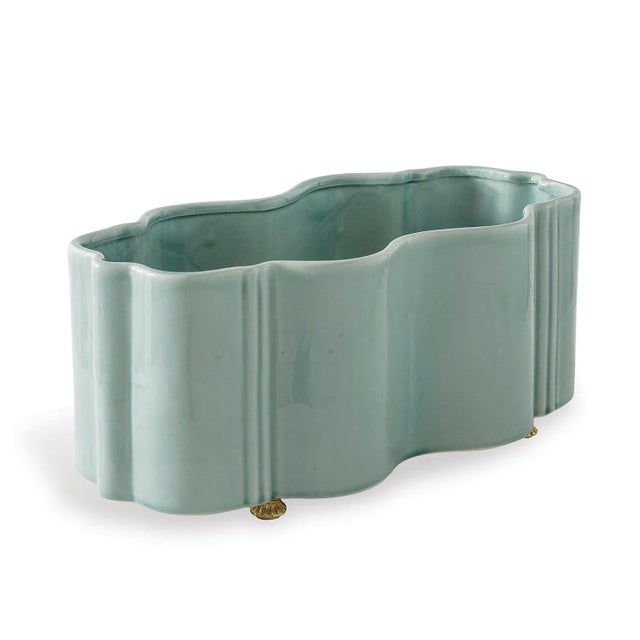 The tuscan planter features scalloped curves cast into porcelain. The movement of the shape is fresh and bold. Accented...