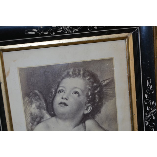 This is a great looking deep picture frame. Possible Eastlake. Wood/mother of pearl & a marble like look. It has a picture...