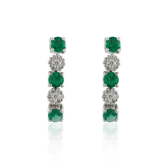This is part of Chairish’s Fine Jewelry assortment. Emerald Diamond Dangle Earrings in 14K gold to make a statement with...