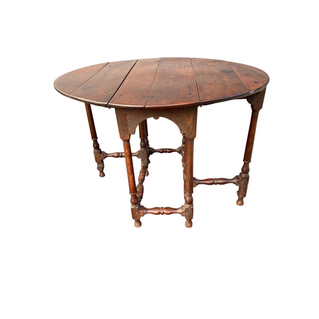 With two D-shaped drop leaves, turned legs and stretchers. Ex William Hodgins.