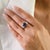 This elegant three-stone ring feature 1 oval cut blue sapphires totaling 2.16 carats set in rich 18k white gold. The...