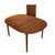 Solid teak Danish modern dining table with a clean oval top and integrated extension leaf. The table has been freshly...