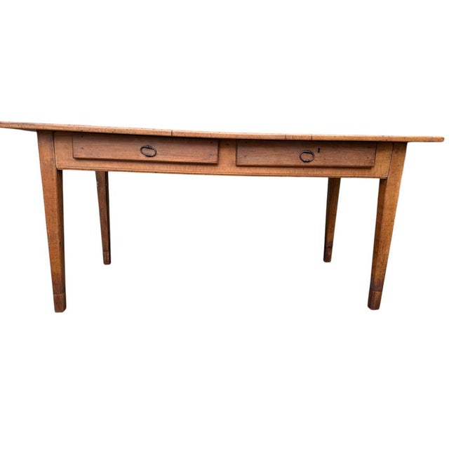 Magnificent Louis Philippe farmhouse table in cherry wood. Two drawers. 19th century. Tapered legs. The legs have been...