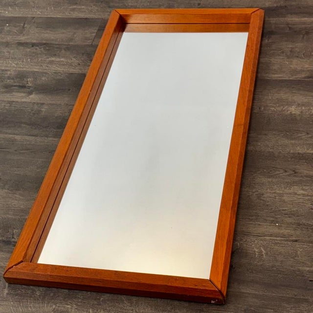 Substantial heft to this mirror. Solid teak all around, with interesting 45 degree miter cuts at the corners. We scoured...