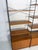A charming wall unit designed and manufactured by whb in germany during the 1960s. It features a sleek black lacquered...