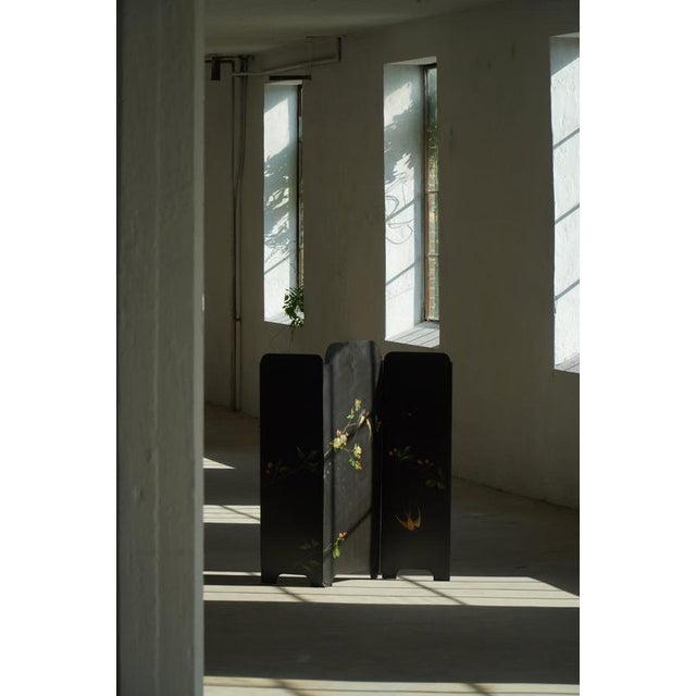 A charming three-panel folding screen crafted in iron and dating from the mid-20th century. Finished in black, the screen...