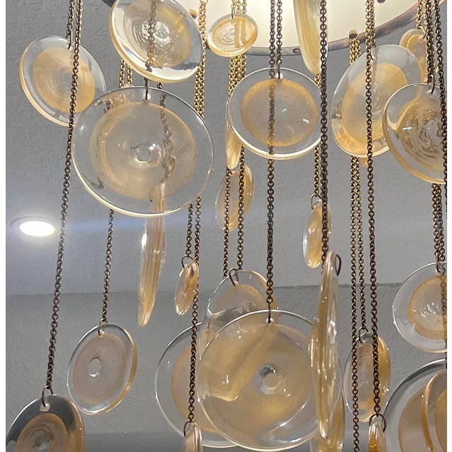 The Laura Kirar Syro Ceiling Pendant (Model BA300) is a luxury designer light fixture featuring hand-blown polished...