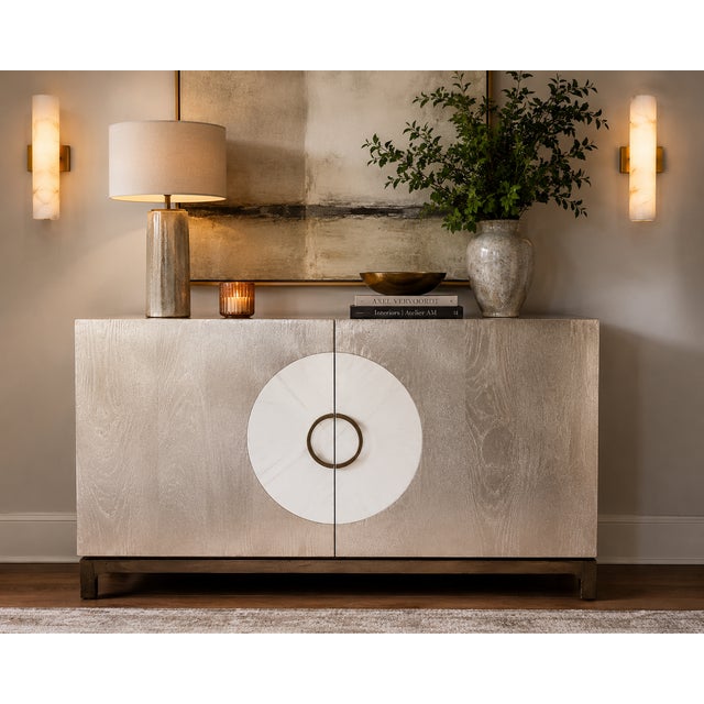 Striking Theodore Alexander two-door credenza featuring a textured silver-leaf finish with visible wood grain and a...