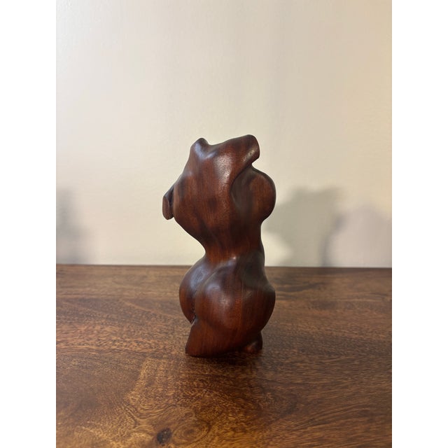 A sculptural hand carved mahogany female torso, celebrating the natural curve and form of the body. Carved from a solid...