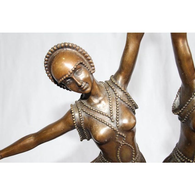 After demétre chiparus. An art deco style bronze figure of two dancers. Mid-20th century. Of mid brown patination. On a...