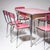 Dining set consisting of a table and six chairs in chrome-plated metal with a pink Formica surface. Showing age-related...