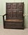 The Settle has a superbly carved high panelled back with 8 panels carved in a Celtic design with the sun at the centre...