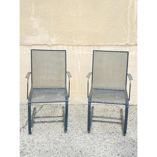 Vintage Mid Century Modern Wrought Iron Metal Mesh Cantilever Garden Patio Chairs - a Pair. Circa Mid 20th Century....