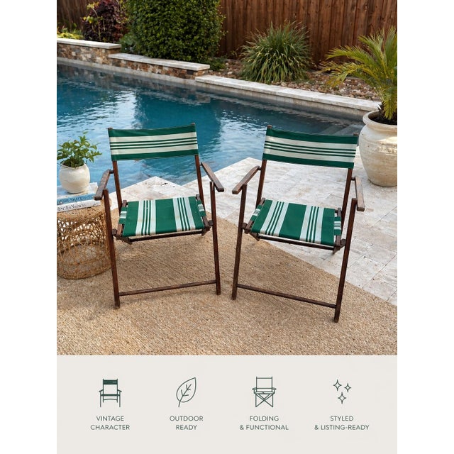 classic pair of mid-century folding patio chairs featuring warm stained wood frames and original green striped canvas...