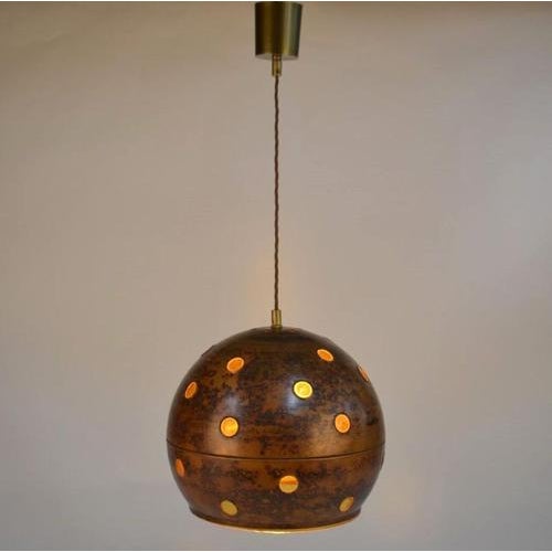 Pair of copper and amber glass pendant lamps, hand blown glass by Nanny Still for Raak. They are each unique in execution....